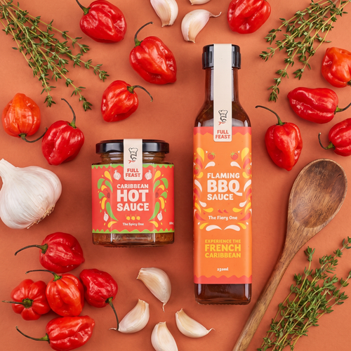 Full Feast Caribbean Hot Sauce jar and Flaming BBQ Sauce bottle with scotch bonnet chillies, garlic and thyme